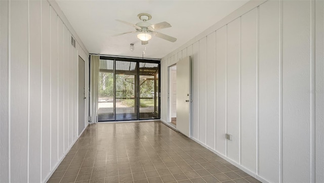 interior space featuring a wall of windows and wooden walls