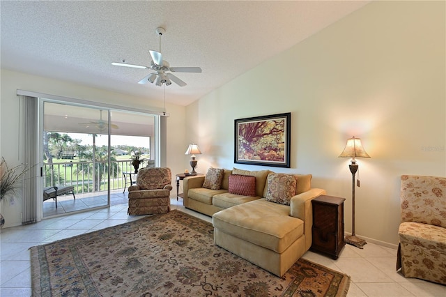 tiled living room with ceiling fan, lofted ceiling, and a textured ceiling