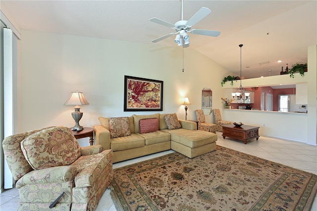 tiled living room featuring ceiling fan with notable chandelier and vaulted ceiling