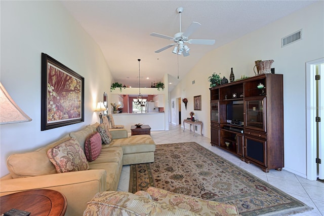 tiled living room featuring ceiling fan with notable chandelier, vaulted ceiling, and a textured ceiling