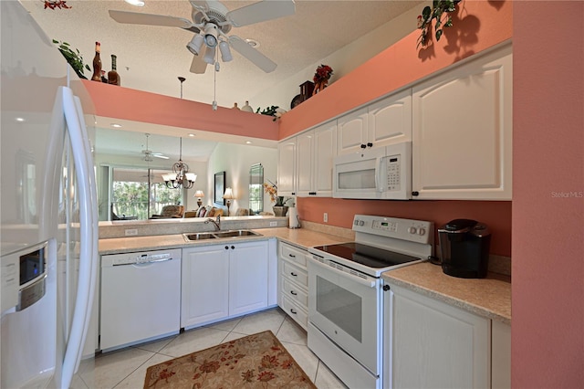 kitchen featuring sink, light tile patterned floors, pendant lighting, white appliances, and white cabinets