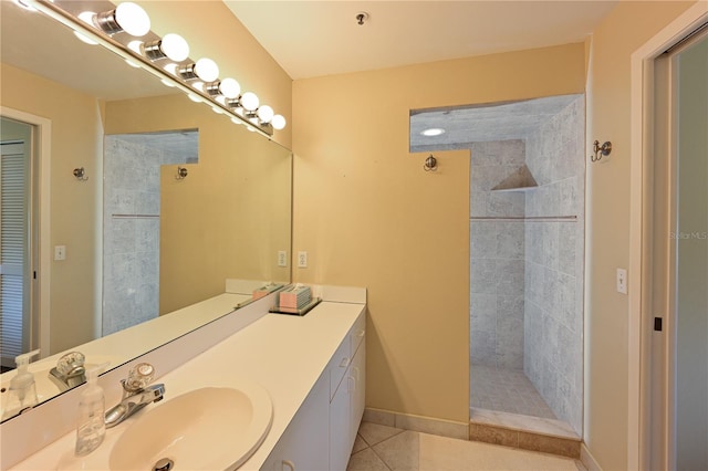 bathroom featuring vanity, tiled shower, and tile patterned floors