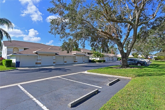 view of car parking with a yard