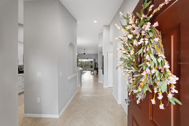 corridor with a high ceiling and light tile patterned floors