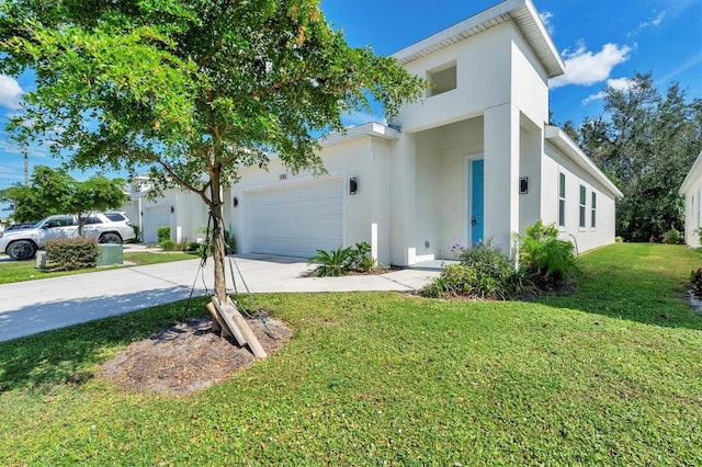 view of front of property featuring a garage, a front lawn, concrete driveway, and stucco siding