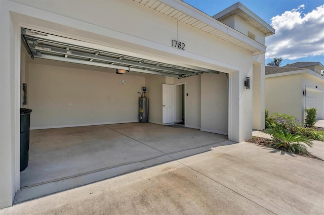 garage featuring a garage door opener and water heater