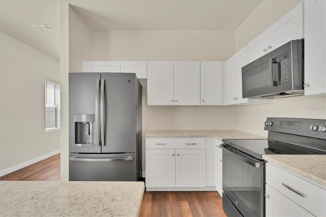 kitchen with white cabinetry, black appliances, and dark hardwood / wood-style floors