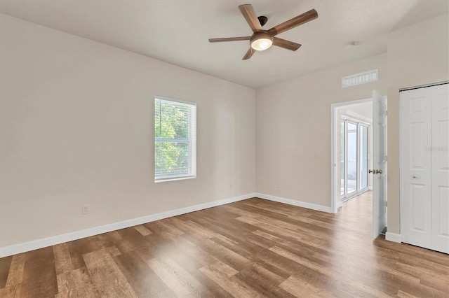 spare room featuring light wood-type flooring and ceiling fan