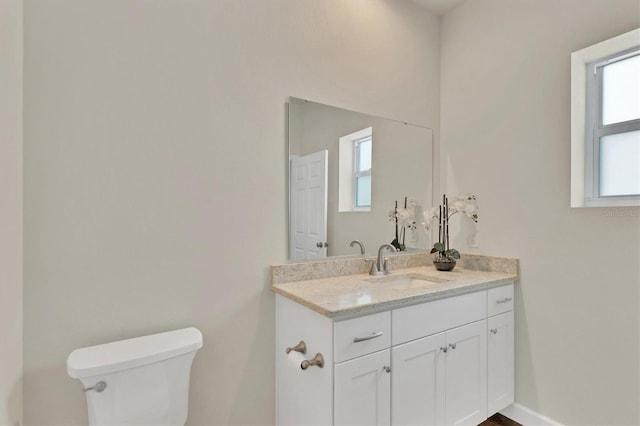 bathroom featuring toilet and vanity