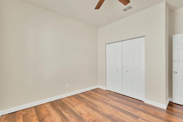 unfurnished bedroom with a closet, ceiling fan, and wood-type flooring