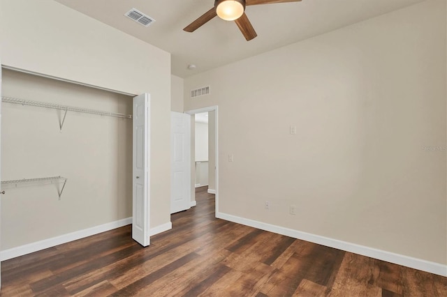 unfurnished bedroom featuring dark hardwood / wood-style floors, a closet, and ceiling fan