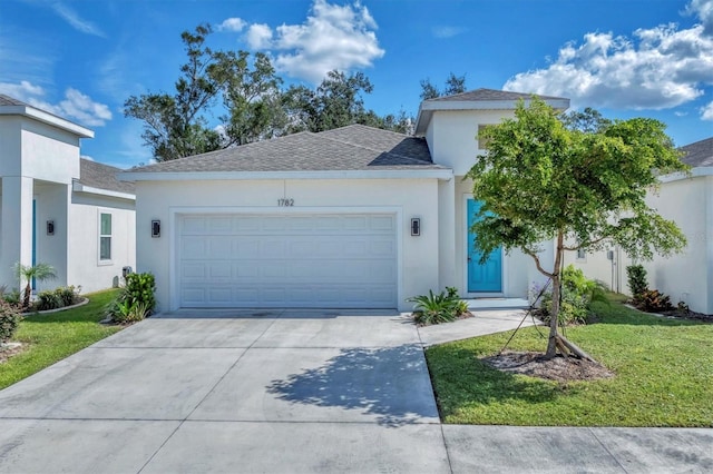 view of front of home with a front yard and a garage