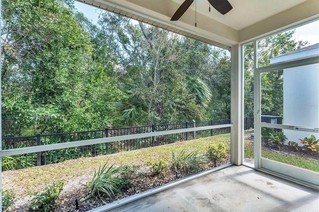 unfurnished sunroom featuring ceiling fan