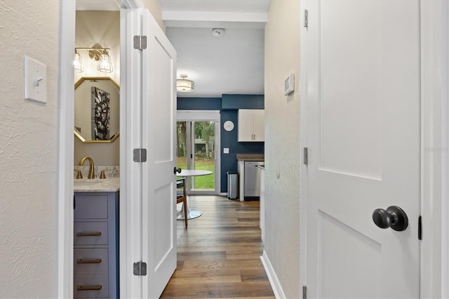 hall featuring hardwood / wood-style floors and sink