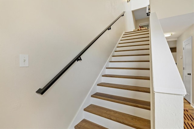 staircase with wood-type flooring