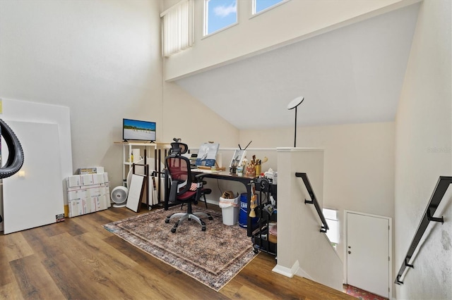 home office with wood-type flooring and high vaulted ceiling