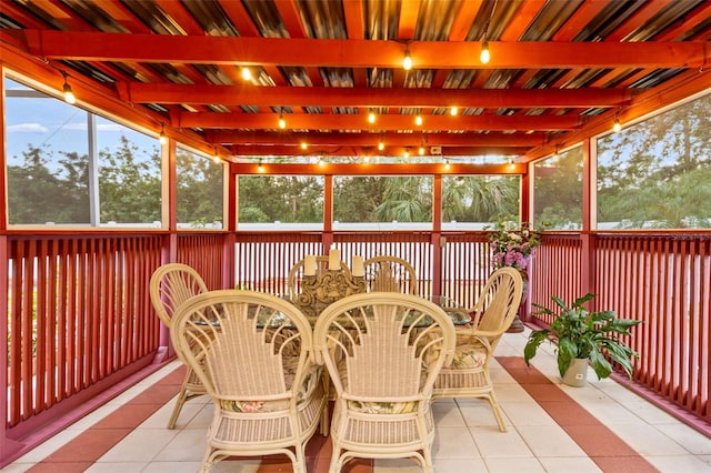 sunroom featuring beamed ceiling