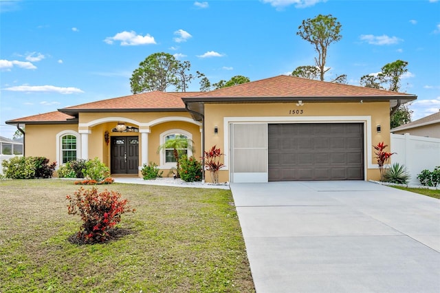 view of front of property featuring a garage and a front yard