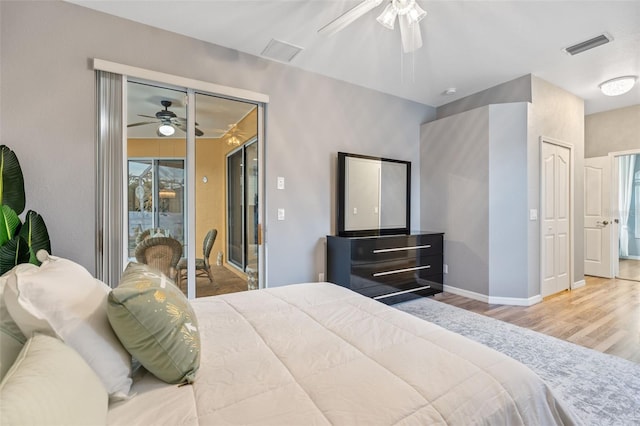 bedroom with hardwood / wood-style flooring, ceiling fan, access to exterior, and a closet