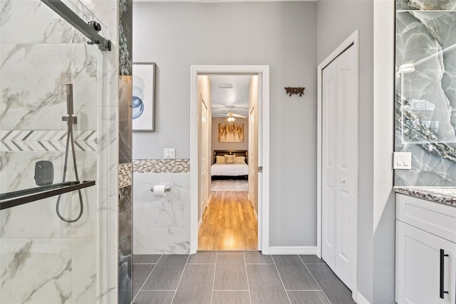 bathroom featuring vanity and tiled shower