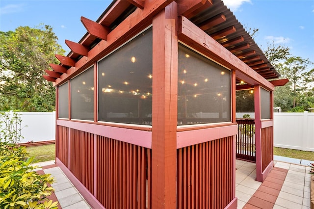 view of property exterior with a sunroom