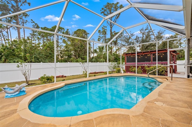 view of pool featuring a sunroom, glass enclosure, and a patio