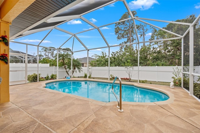 view of swimming pool with glass enclosure and a patio area