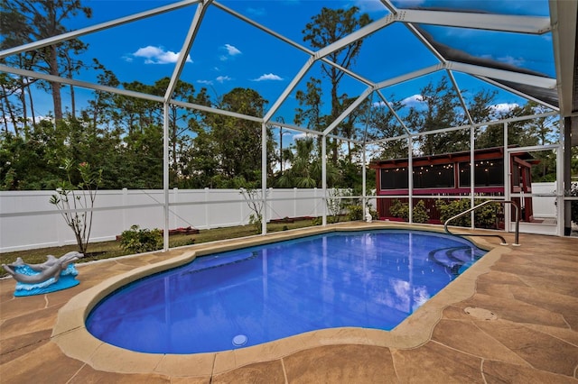 view of swimming pool with a lanai and a patio area