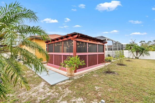 exterior space featuring a sunroom and a lawn