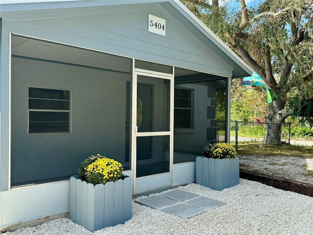 view of side of home featuring a sunroom