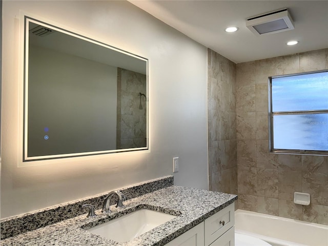 bathroom featuring vanity and tiled shower / bath combo