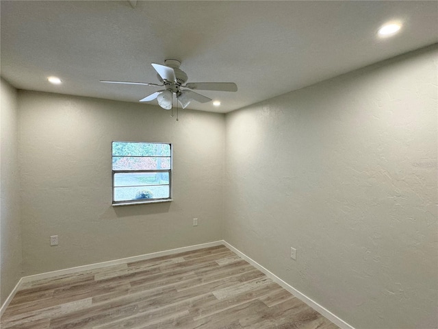 unfurnished room featuring ceiling fan and light wood-type flooring