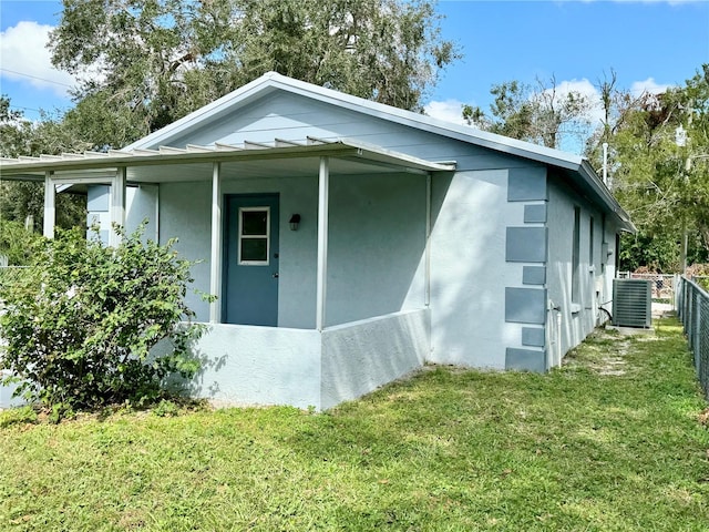 view of home's exterior featuring a yard and central air condition unit