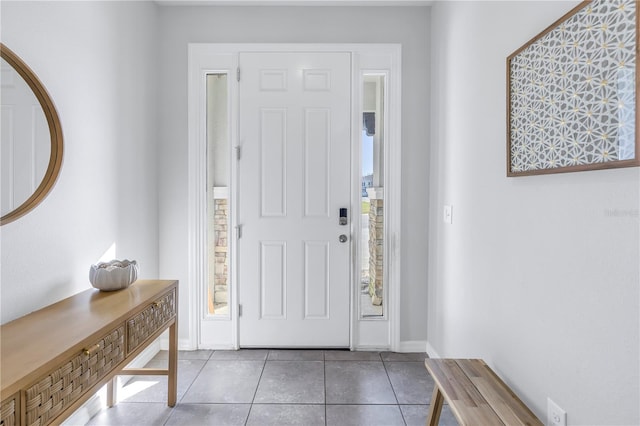 foyer entrance featuring tile patterned flooring and baseboards