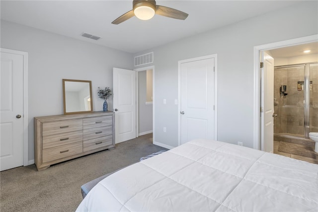 carpeted bedroom with ensuite bathroom, a ceiling fan, visible vents, and baseboards