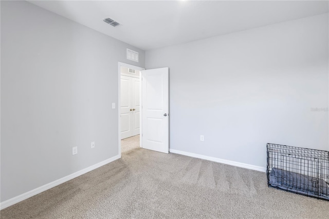 unfurnished room featuring visible vents, baseboards, and carpet flooring