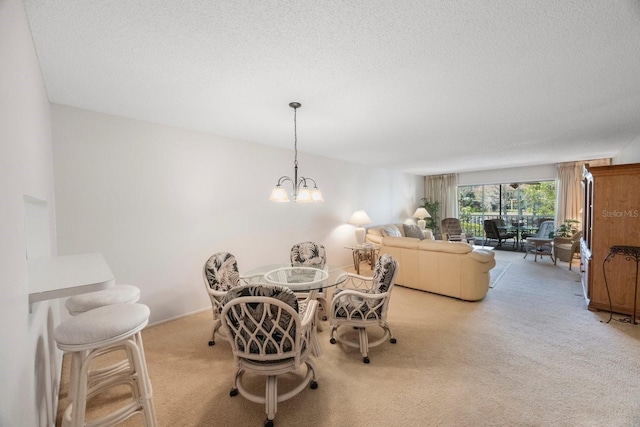 dining room featuring a textured ceiling, light colored carpet, and an inviting chandelier