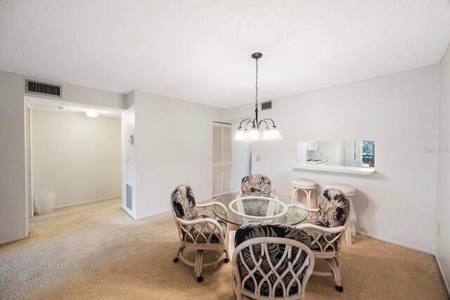 6435 Egret Ln Unit 409, Bradenton, FL 34210 - dining room with carpet flooring, a chandelier, and visible vents
