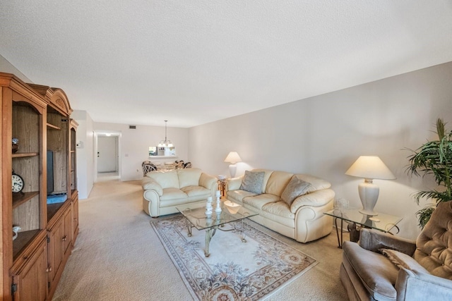 living room featuring light carpet, a textured ceiling, and a chandelier