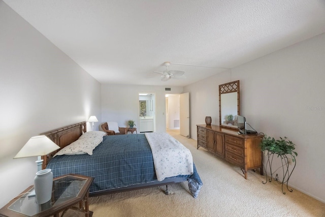 carpeted bedroom featuring a textured ceiling and ceiling fan