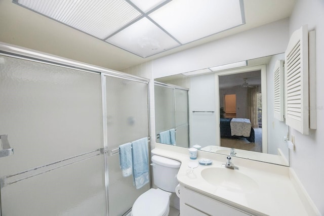 bathroom featuring vanity, toilet, and an enclosed shower