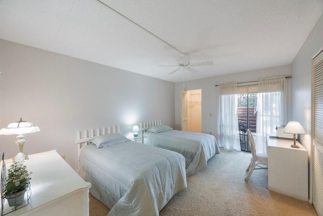 carpeted bedroom with a textured ceiling, a closet, and ceiling fan