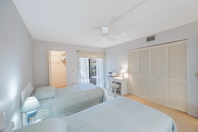 carpeted bedroom featuring a closet and ceiling fan