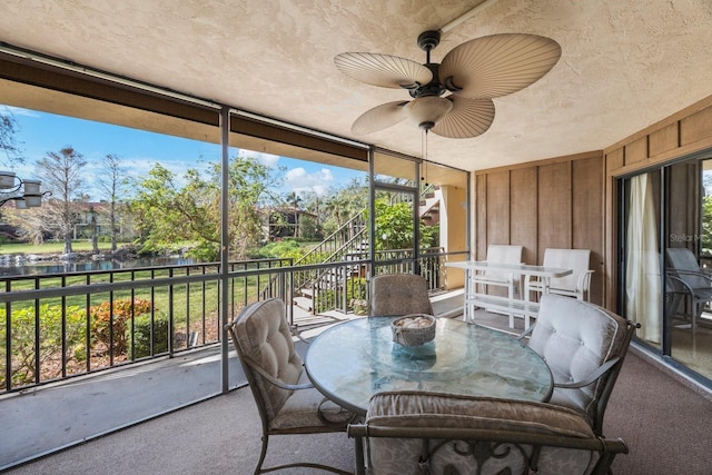 sunroom / solarium featuring a healthy amount of sunlight and ceiling fan