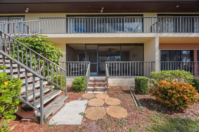 6435 Egret Ln Unit 409, Bradenton, FL 34210 - view of exterior entry featuring stucco siding and a balcony