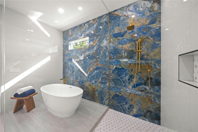 bathroom featuring separate shower and tub and tile walls