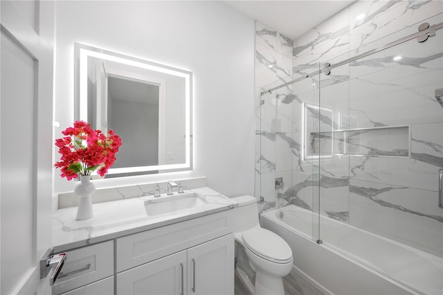 full bathroom with vanity, toilet, and enclosed tub / shower combo