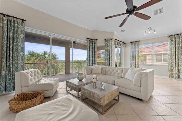 tiled living room with ceiling fan, crown molding, and lofted ceiling