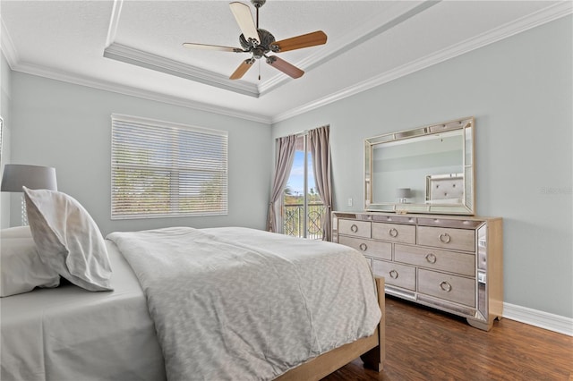 bedroom featuring ornamental molding, ceiling fan, dark hardwood / wood-style floors, and a tray ceiling