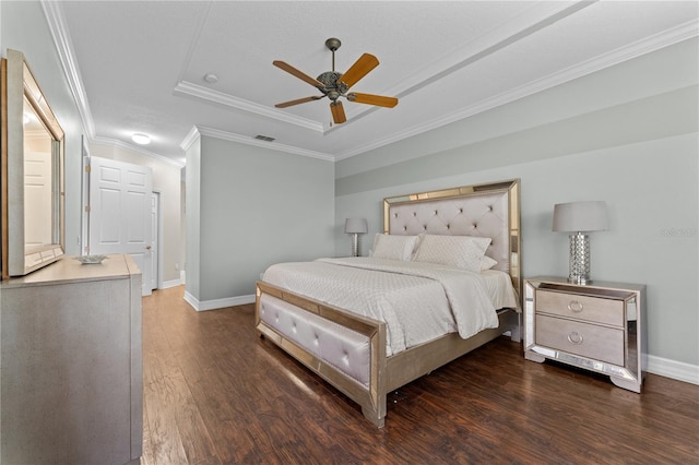 bedroom with ornamental molding, dark wood-type flooring, ceiling fan, and a raised ceiling